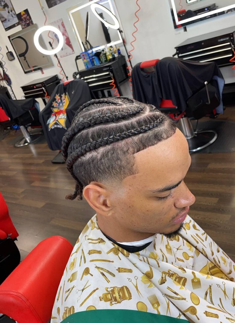 Cornrows braided back with a clean mid fade